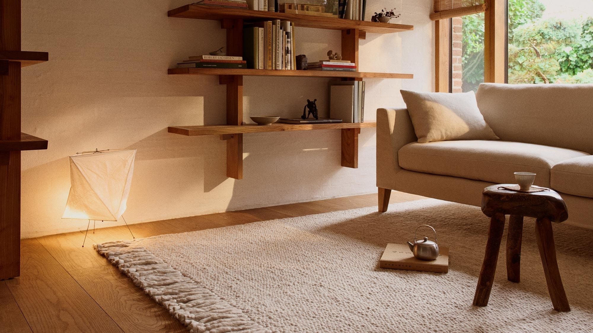Living room with sofa, shelf and large white rug