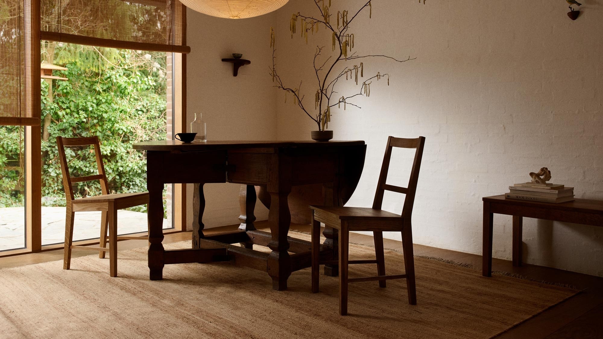 Dining room with large windows and table and chairs on a large hemp rug