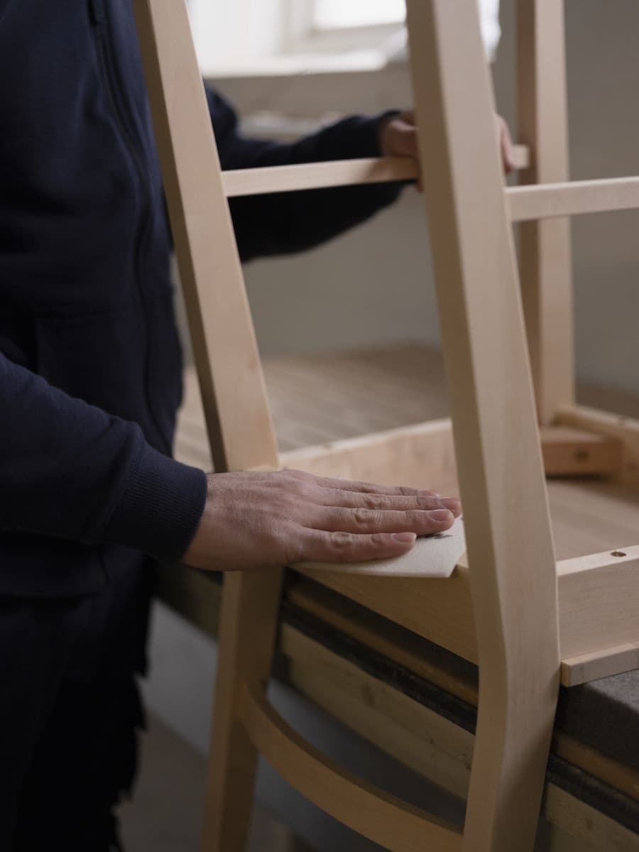 a chair is sanded by hand