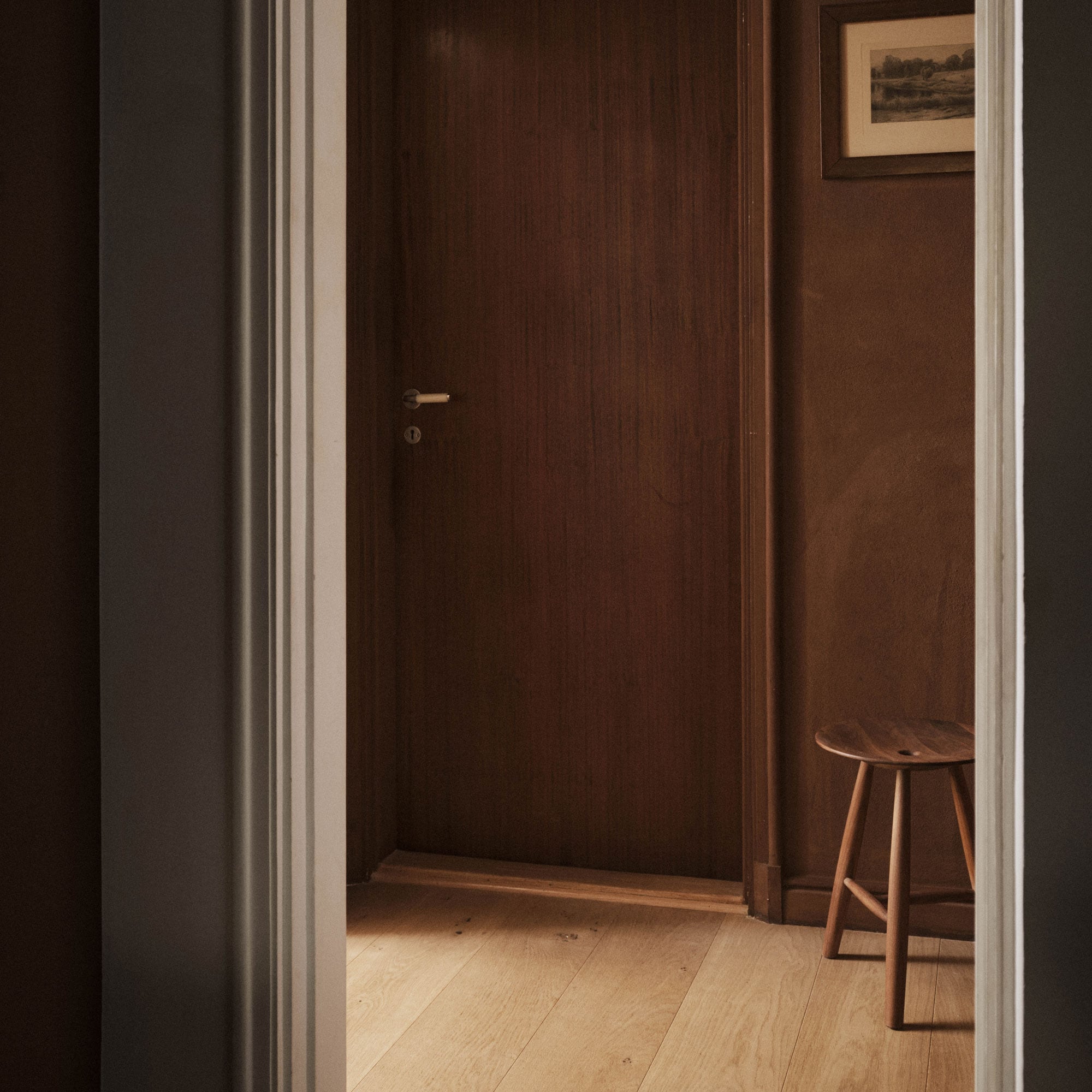 Oiled oak stool in a doorway
