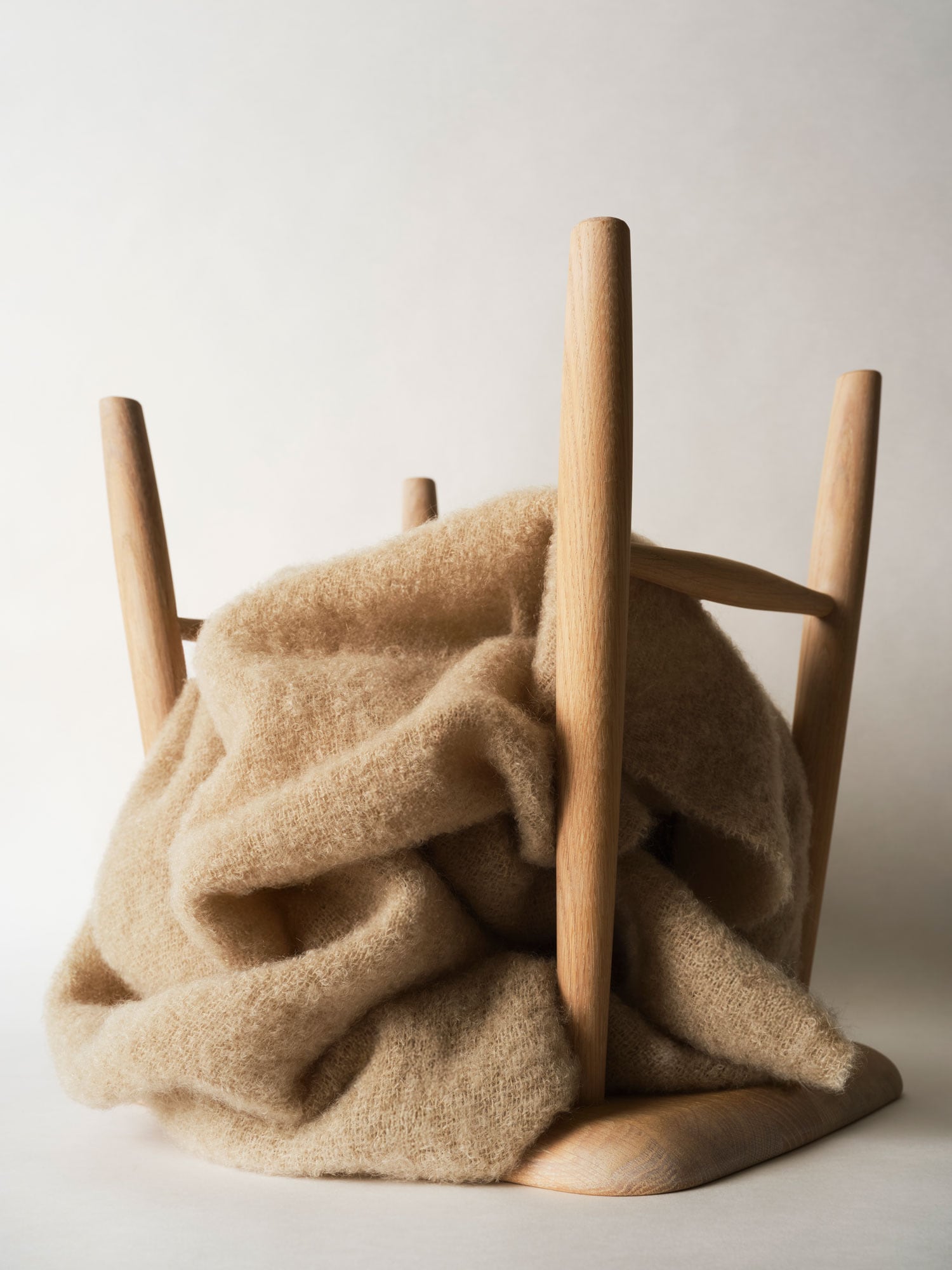 Upside-down stool with a blanket on top